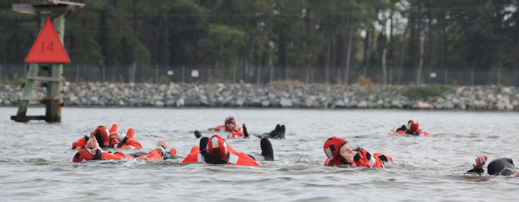 seven sailors splash and swim, sharpening survival skills