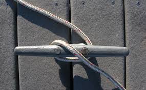 A line is started around a dock cleat.