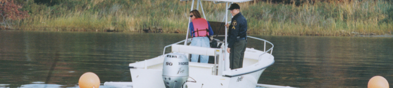 A vessel operator backs the boat under the supervision of a law enforcement officer.