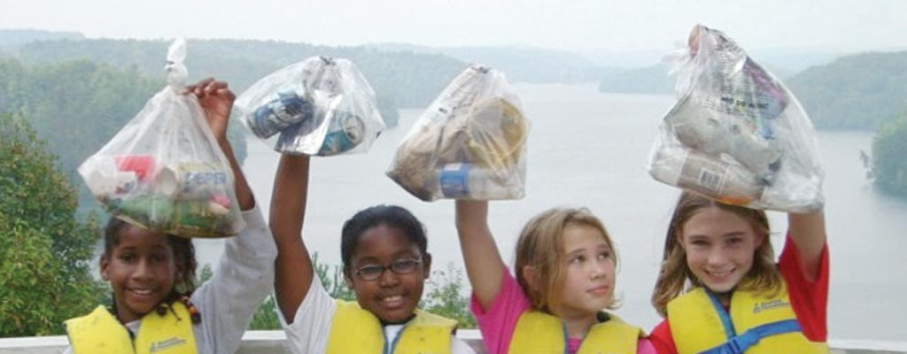 four children cleaning up trash