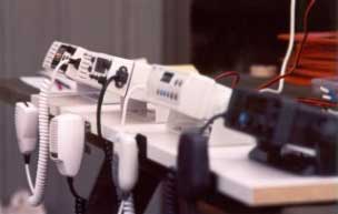 4 fixed mount VHF radios sitting side by side.