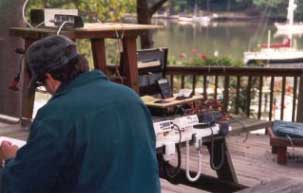 A tester writes conclusions while seated next to the four test units.