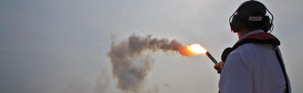 A man holds a combustable flare