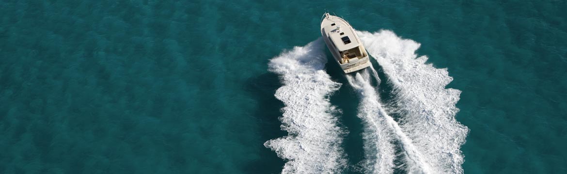 a boat driving through blue water