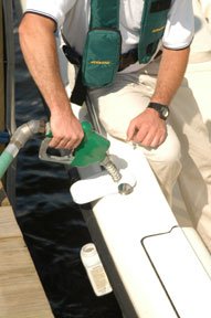 An attentive boater fuels his boat.