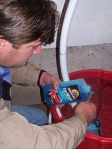 A tester prepares a solution of soap and water for the test.