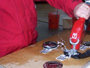 A failed test of the fuel fill system shows soapy water (representing fuel) splashing out of the fuel fill.