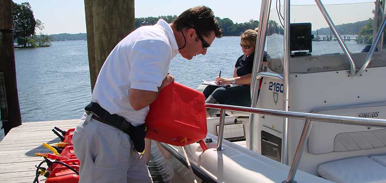 a man fills his fuel tank with a jerry jug