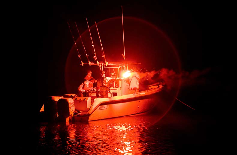 A center console is illuminated by a red flare.