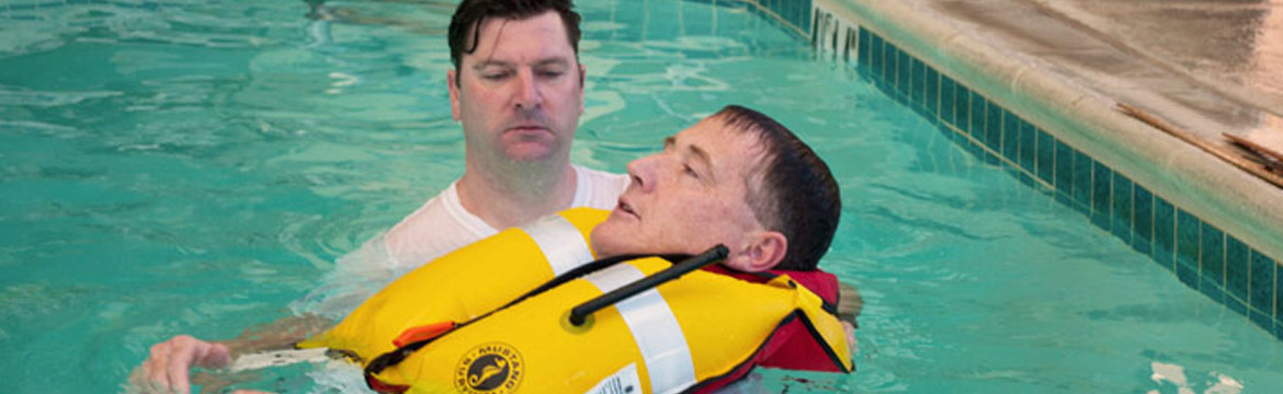Two men test life jackets while in a pool