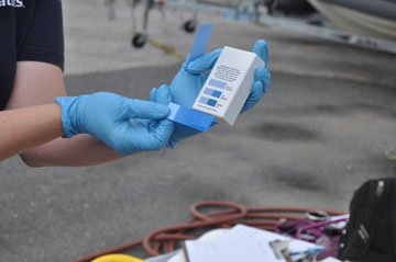 someone measuring the oil content of water