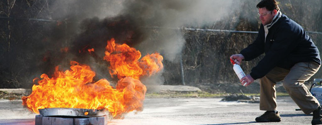 a man puts out a fire with an extinguisher