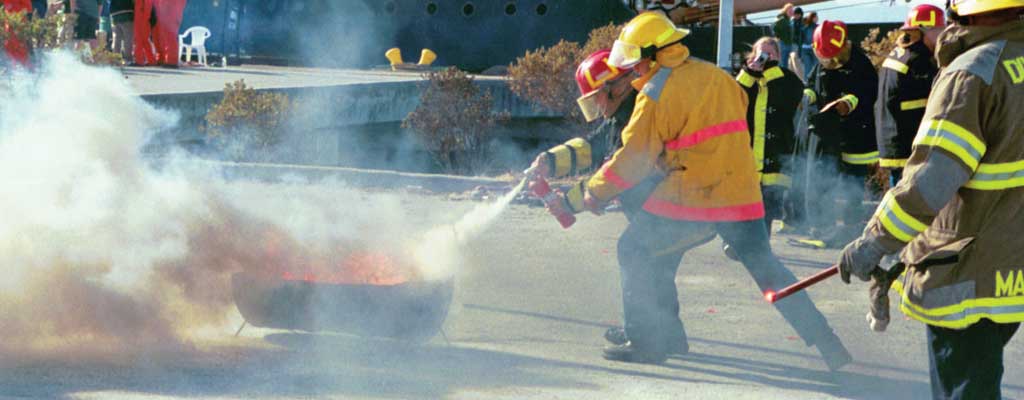 firemen put out a fire with an extinguisher