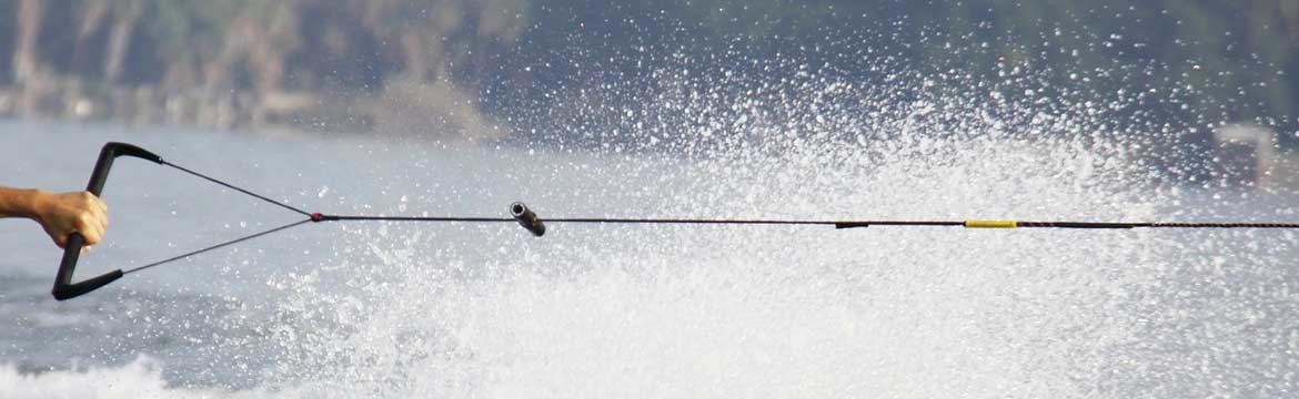 a man waterskiing holds on to his rope