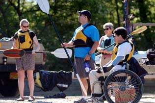 a group of people examine paddles