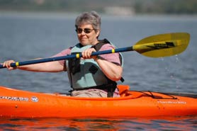 a woman paddles a kayak