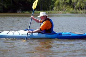 a man paddles his kayak