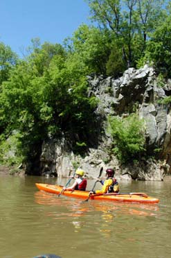 a couple paddles a kayak