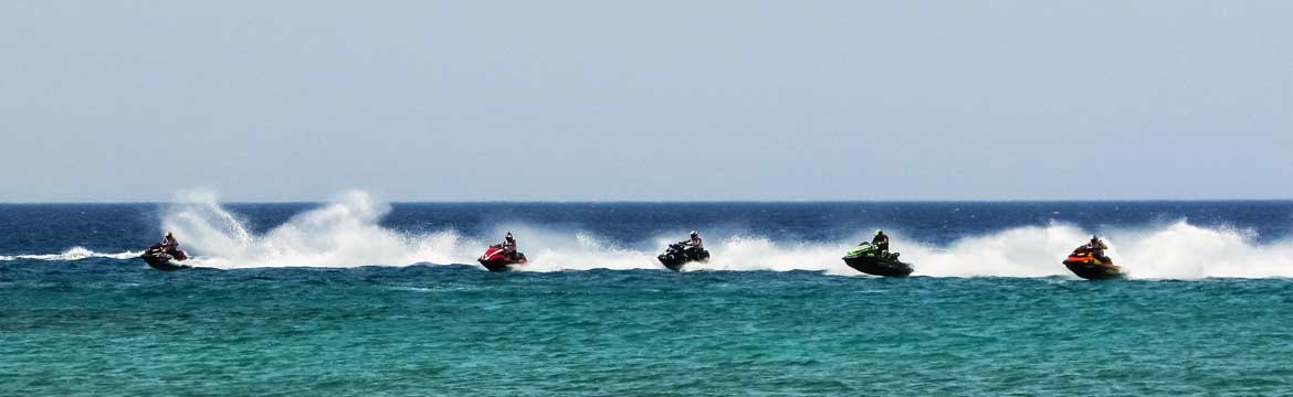 a group of jetski racers racing