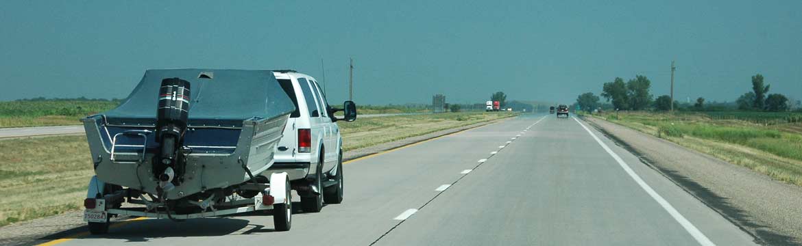 a boat being trailered on a highway