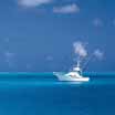 a white boat on blue water